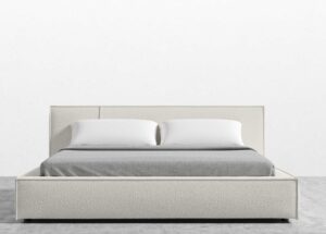 lit sur un mur blanc et un plancher gris
