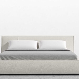 lit sur un mur blanc et un plancher gris